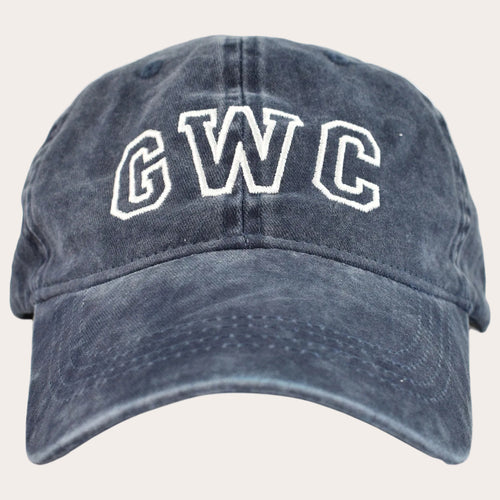 A washed navy blue baseball cap with 'GWC' embroidered in white varsity-style block letters on the front, shown against a plain white background.