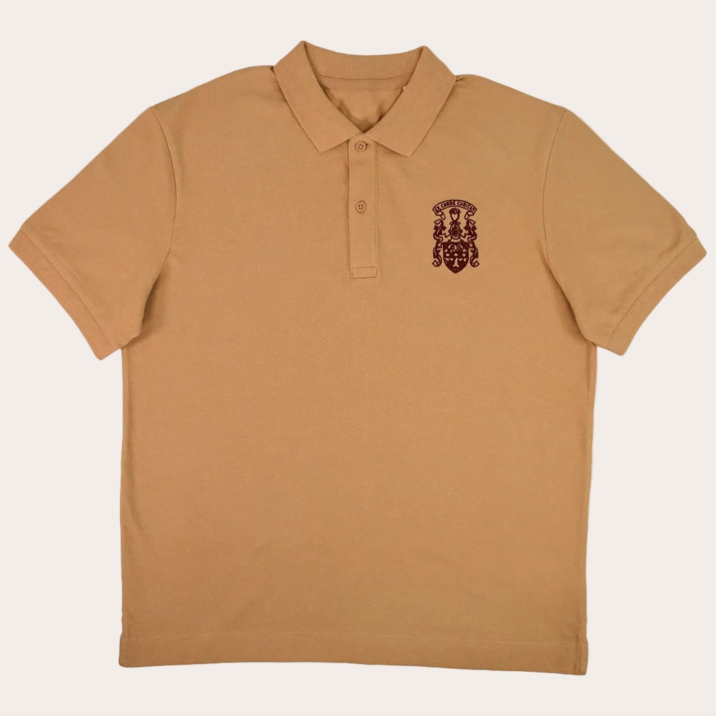 A tan short-sleeve polo shirt with a small dark brown embroidered crest on the left chest, displayed flat against a solid white background.